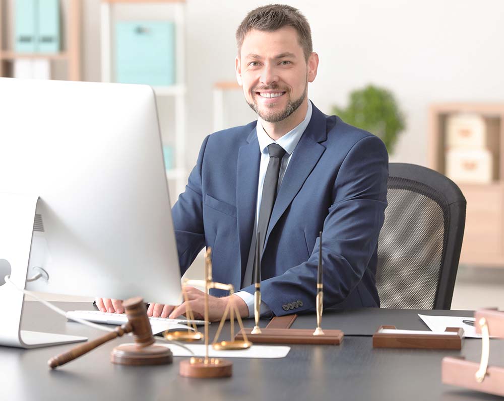 tempe arizona attorney sitting at desk in front of computer