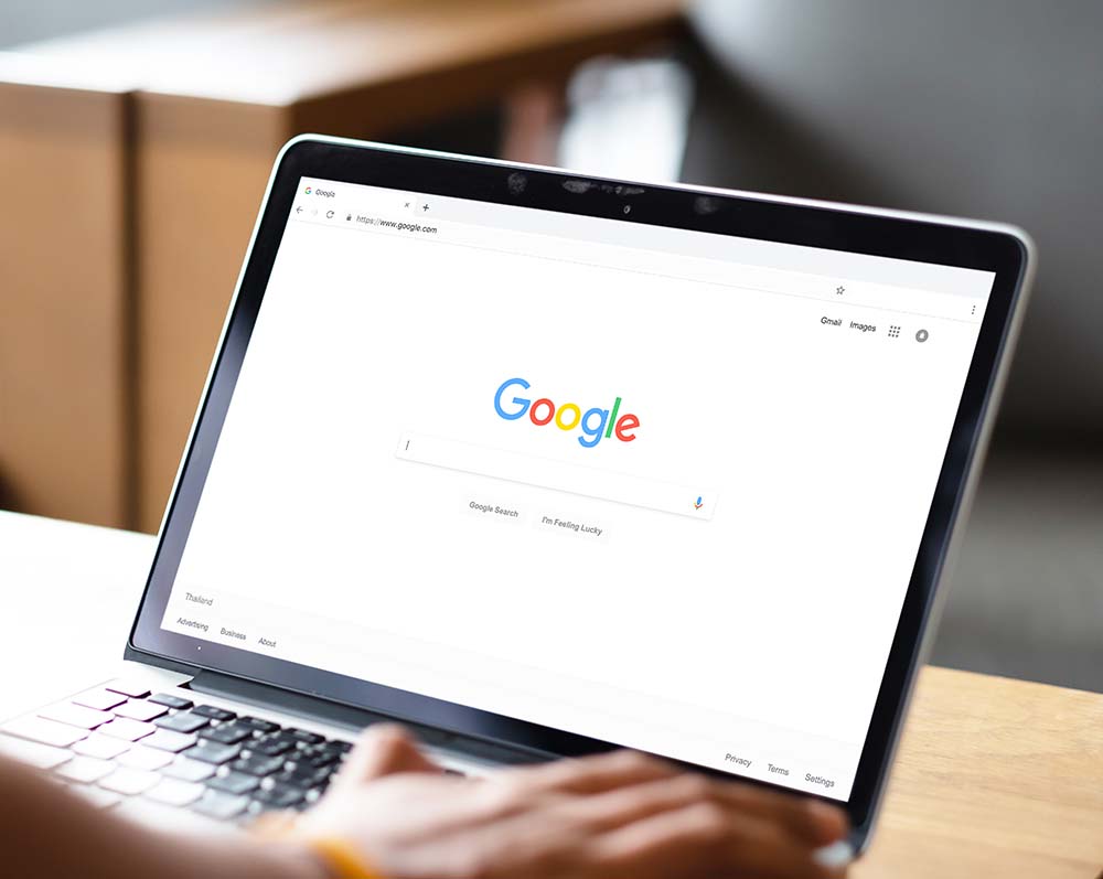 google search engine page open on laptop placed on desk
