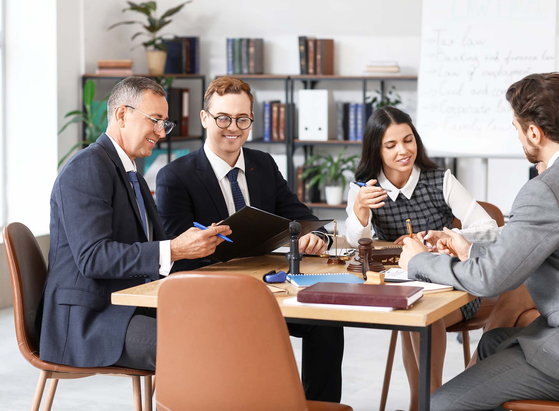 Group of surprise az attorneys working around table in arizona law firm