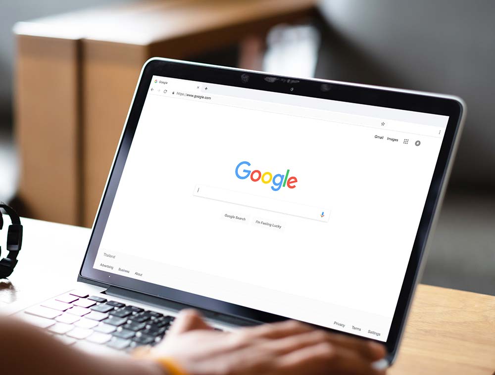 google search engine webpage open on laptop sitting on desk
