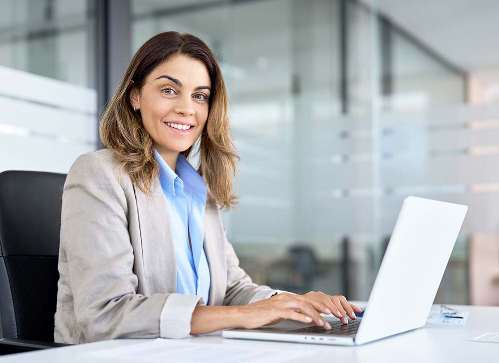 woman attorney sitting in law firm conference room working on laptop in Long Beach, CA