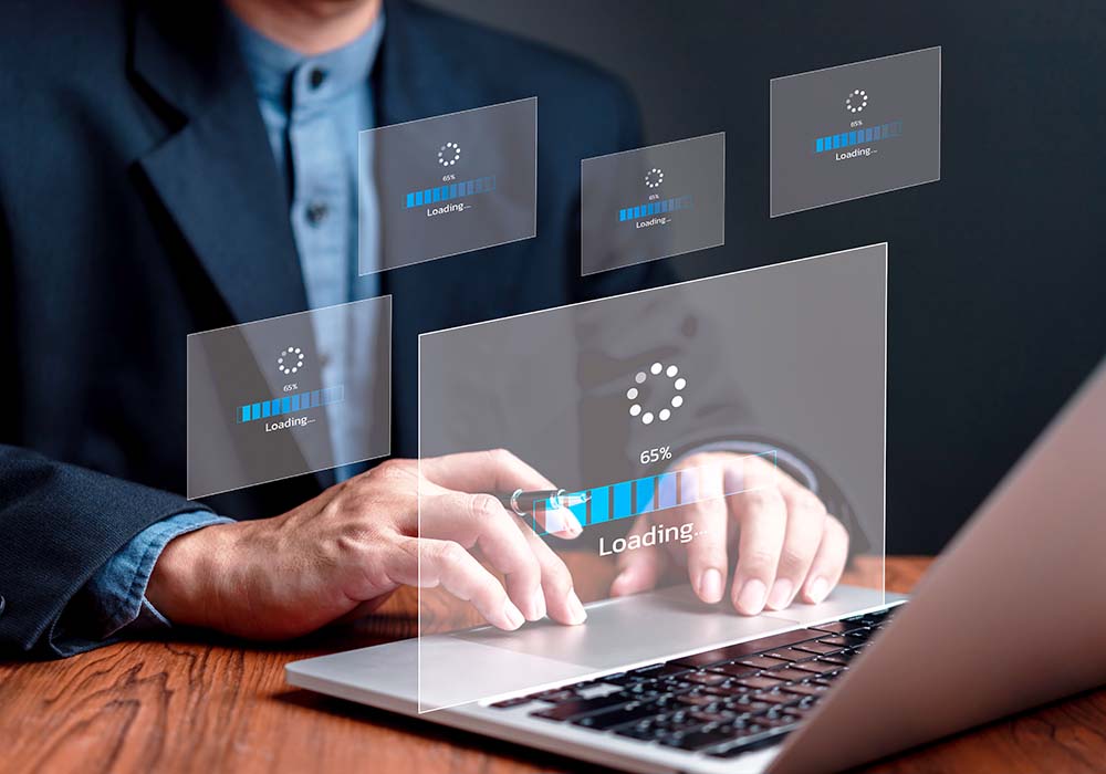man sitting at laptop with several web pages stuck loading