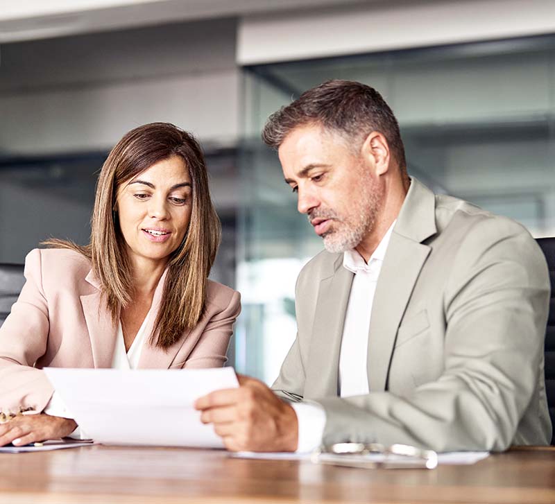 female attorney discussing legal matters with male clients