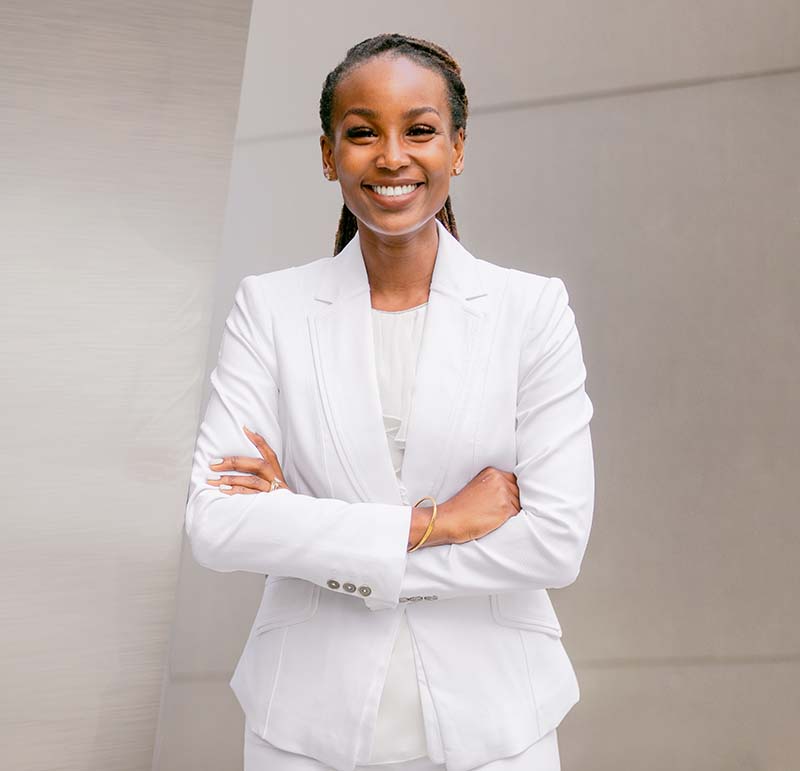 female attorney in white suit with hands crossed