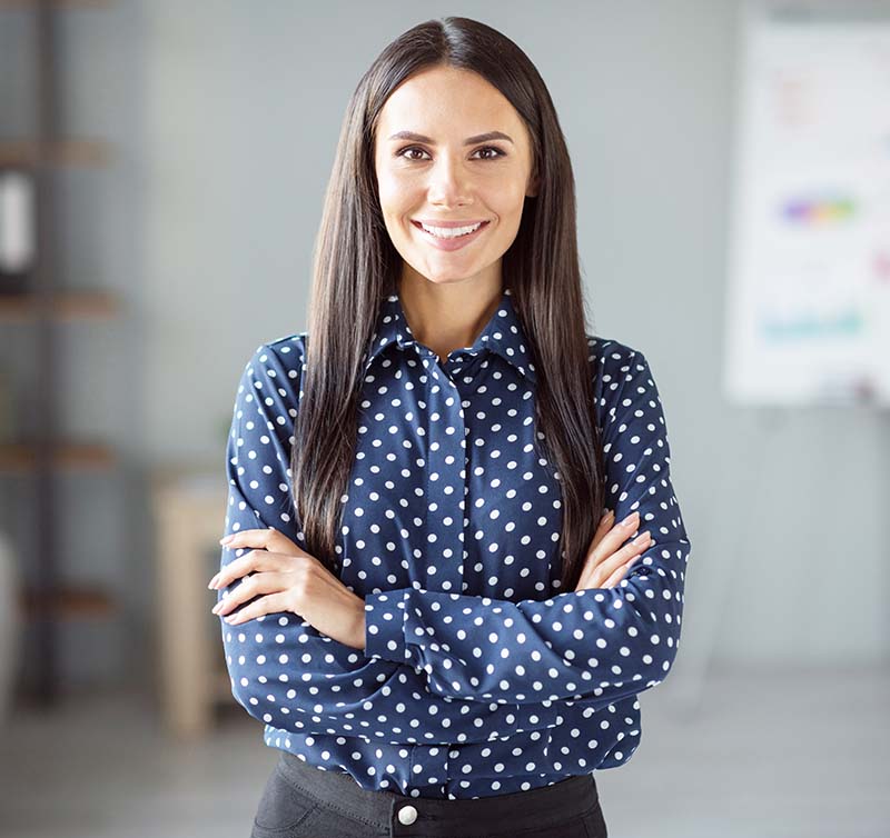 female attorney standing with arms crossed in law firm
