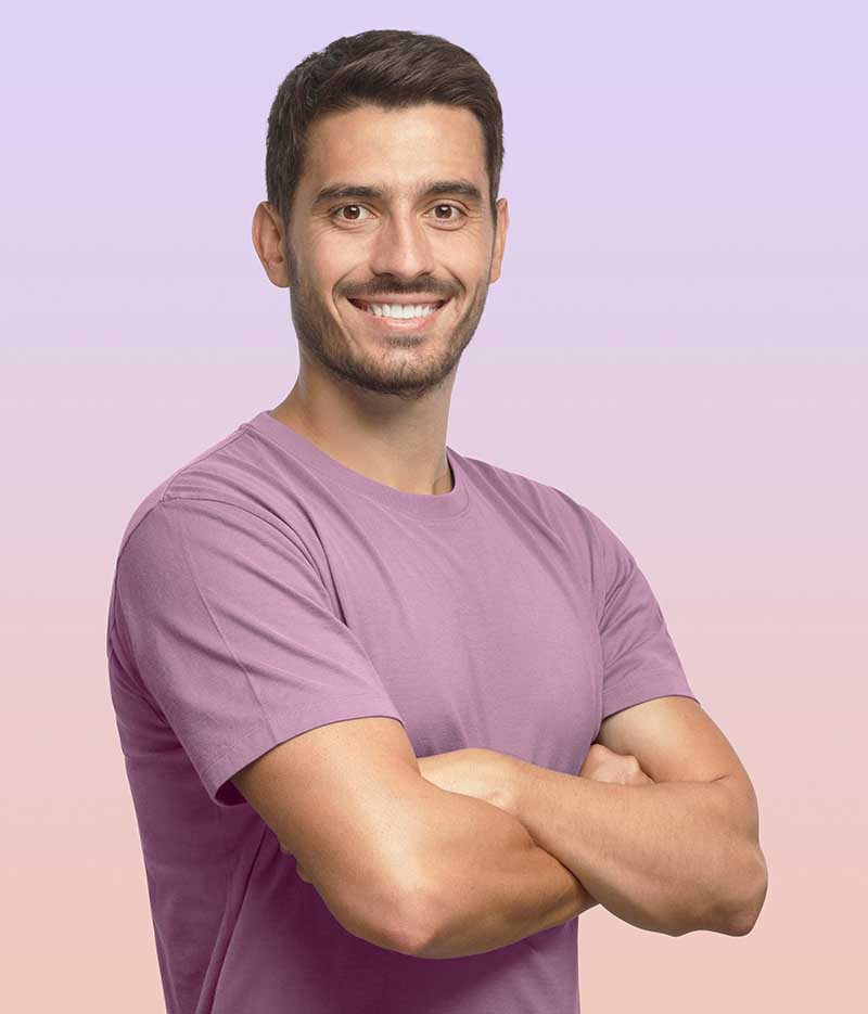 man wearing a light purple shirt smiling