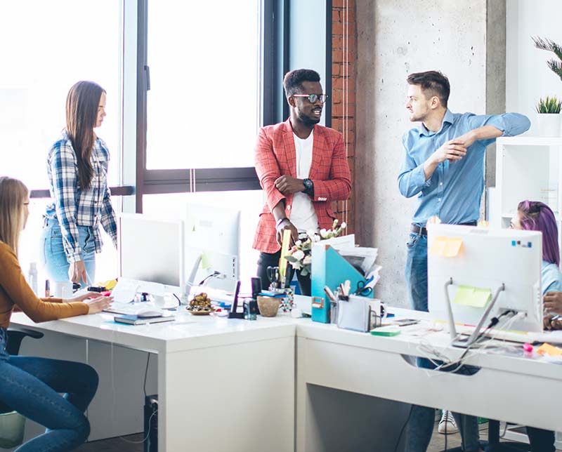 SEO professional and experts for law firm standing around table at digital marketing agency