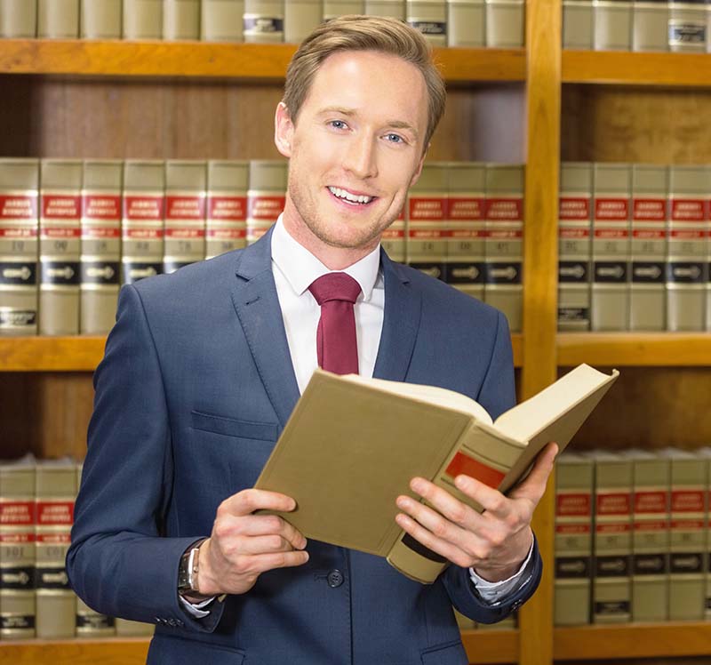 male attorney standing in law firm library
