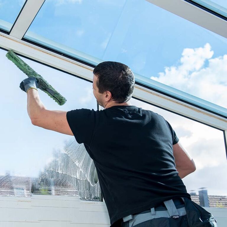 A man cleaning a window