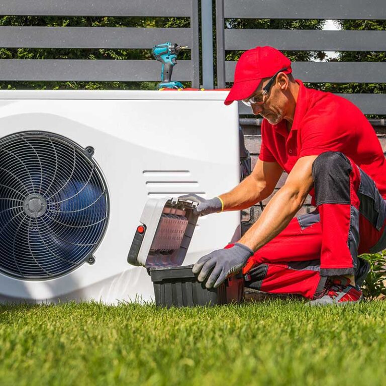 hvac technician working on ac unit