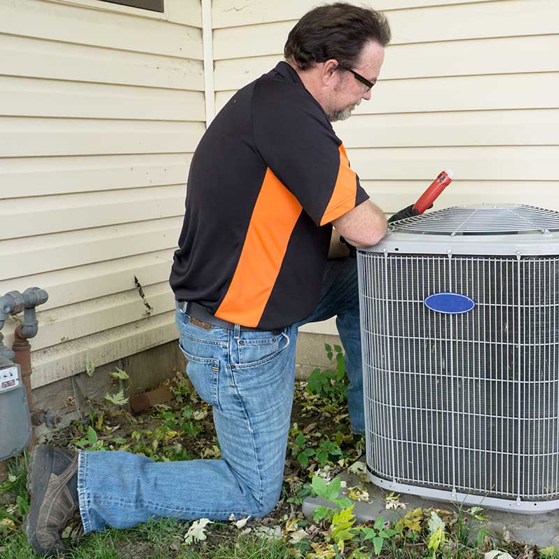 HVAC technician working on cooling system