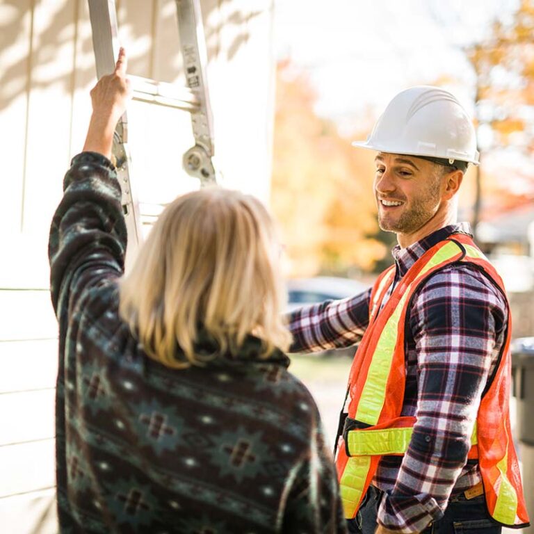 roofing contractor standing outside a client's home