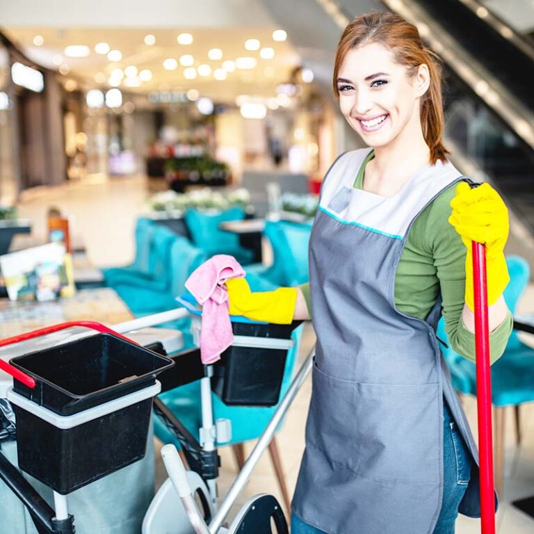 Beautiful young woman cleaning at shopping mall. Cleaning concept.